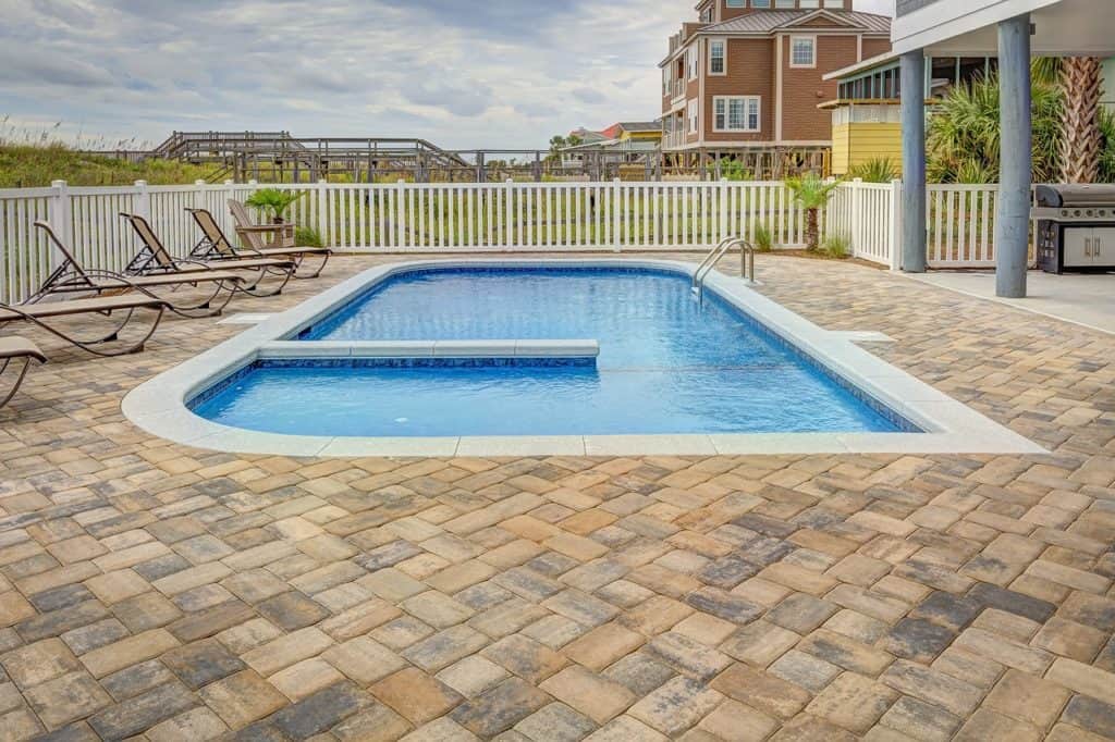 inground pool with chairs